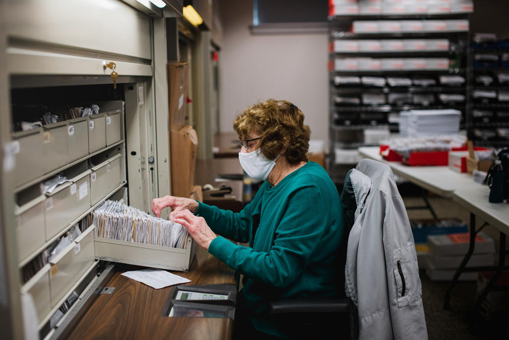 Ellen Ortt looks through old voter registration files at the Voter Registration office in the Lehigh County Government Center in Allentown, Pa. Ortt is looking to see which files need to be update with a new address or a party switch.