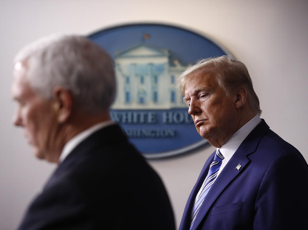 President Trump listens as Vice President Pence speaks during a coronavirus task force briefing in April. A former Pence aide said Trump prioritized his reelection over concern for people getting sick.