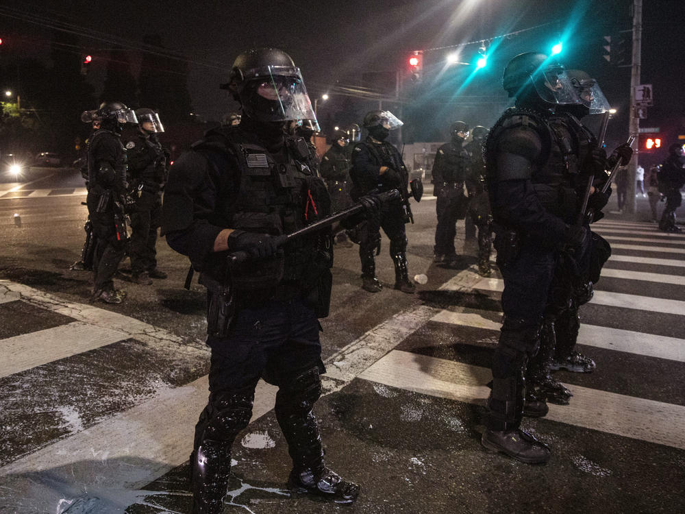 Police stand guard as protesters take to the streets on Sept. 4 in Portland, Ore.