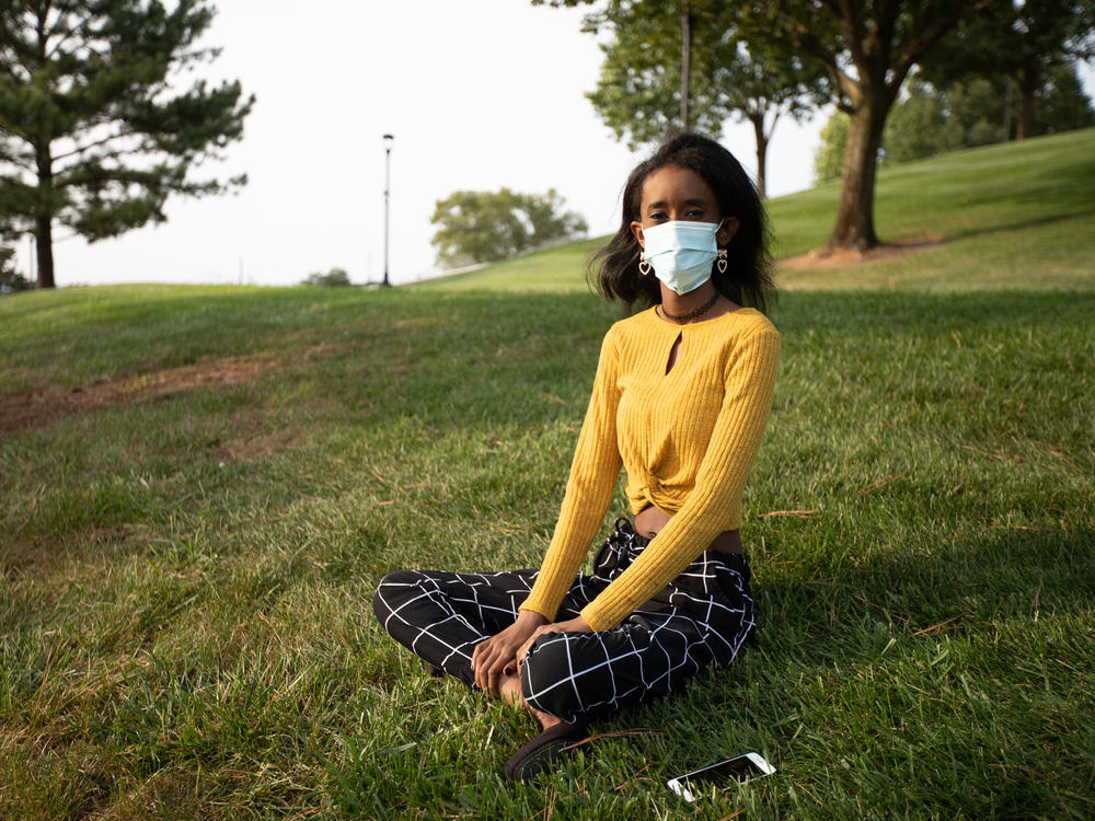 Huda Mohamed, a student at James Madison University in Harrisonburg, Va., has an immunodeficiency. She decided to take extra precautions by using Virginia's COVIDWISE app, which alerts users who may have been exposed to the coronavirus. Such apps are only available in a few states.