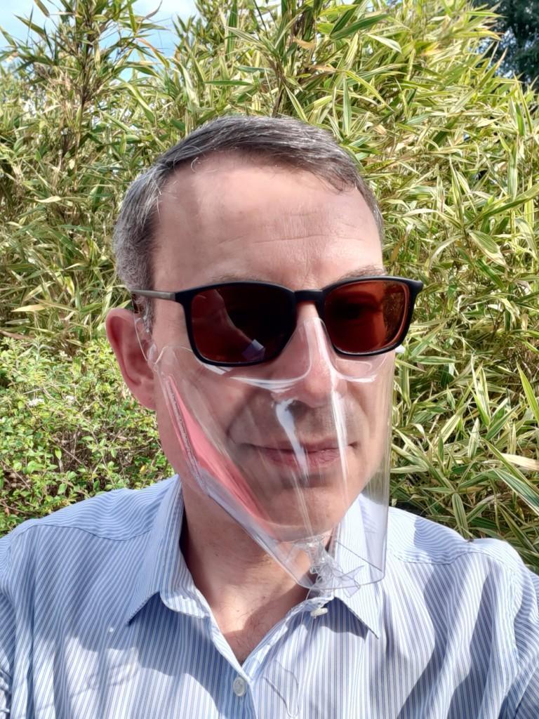 Christophe Bertrand wears an inexpensive mask made of a single plastic sheet, manufactured by his Simon company.