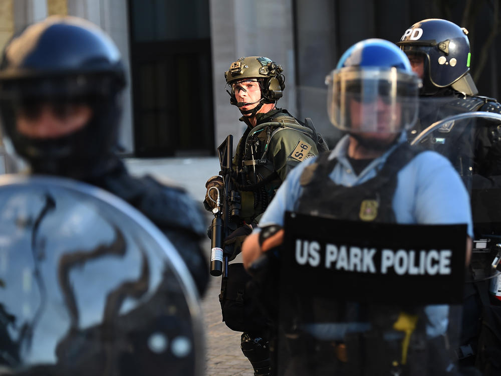 U.S. Park Police and other federal officers hold a perimeter near the White House on June 1 as demonstrators gather to protest the killing of George Floyd.