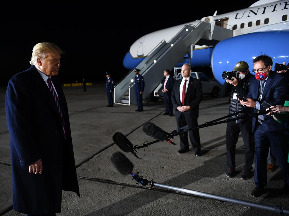 President Trump reacts to the news of Justice Ruth Bader Ginsburg's death on Friday at Bemidji Regional Airport in Minnesota. He told reporters on the tarmac after his rally that he learned the news from them.