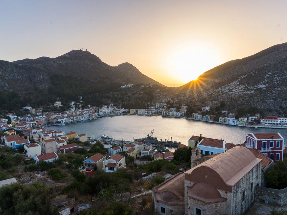 The Greek island of Kastellorizo, shown here at sunset from the top of an ancient castle, is a little over a mile away from the Turkish shore. Known for its architecture, turquoise sea and friendship with the neighbor Turks, it's recently become a pawn in a geopolitical dispute between the Greek and Turkish governments over hydrocarbons and maritime borders.