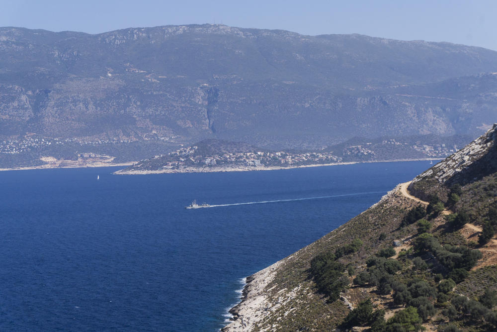 A Greek military ship glides along the stretch of sea between Kastellorizo and the neighboring Turkish town of Kas.