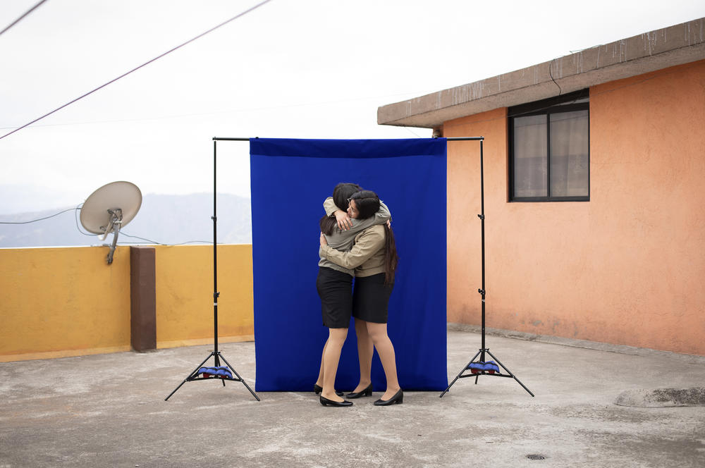 Lisbeth Riera (left), 17, and Leslie Villacís, 18, hug during a pre-graduation portrait session at Leslie's house — the first time the friends had seen each other since a quarantine began four months earlier. The graduation ceremony is off this year 
