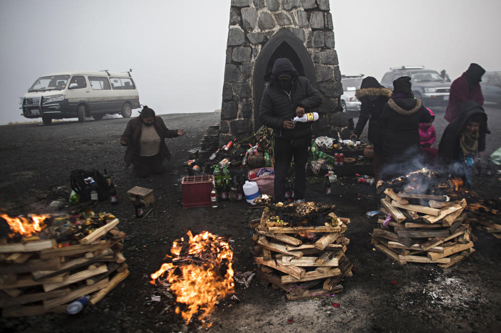 Pandemic or no, indigenous Bolivians celebrate the Mother Earth goddess Pachamama persists in Bolivia. These men and women gave offerings to the goddess in a high-altitude summit in Yungas, a forested ecoregion some 2.8 miles above sea level. <em>August 16. La Paz.</em>