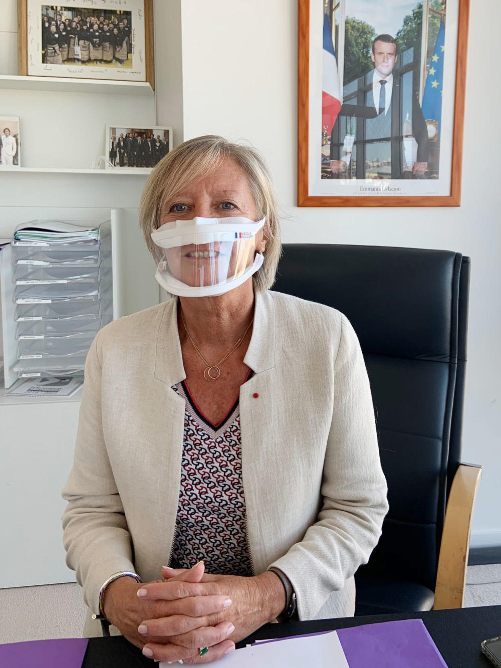 Sophie Cluzel, France's secretary of state in charge of disability issues, demonstrates a transparent mask in her office.
