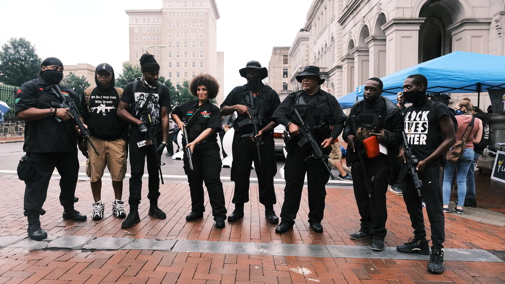 Demonstrators pose for photos with their guns during an open carry rally on Aug. 15 in Richmond, Va. The open carry rally is organized by an activist group known as BLM757 in support of the Black Lives Matter movement and the Second Amendment.