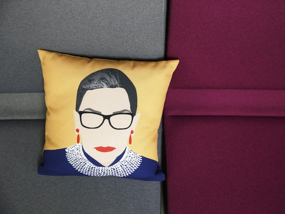 A pillow with Ruth Bader Ginsburg's likeness on it sits on a couch inside the office of ActBlue, a Democratic fundraising platform, in Somerville, Mass.