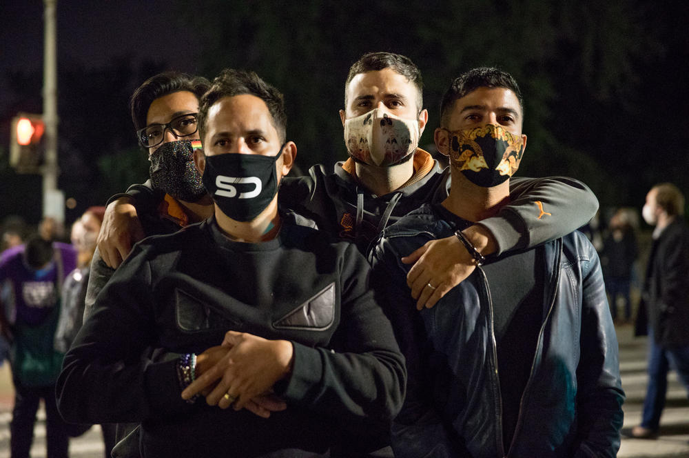 (Left to right) Kelvin Flores, Franklin Ortiz, Steven Zatarga and Shahab Albahar listen to speakers in front of the U.S. Supreme Court during the vigil.