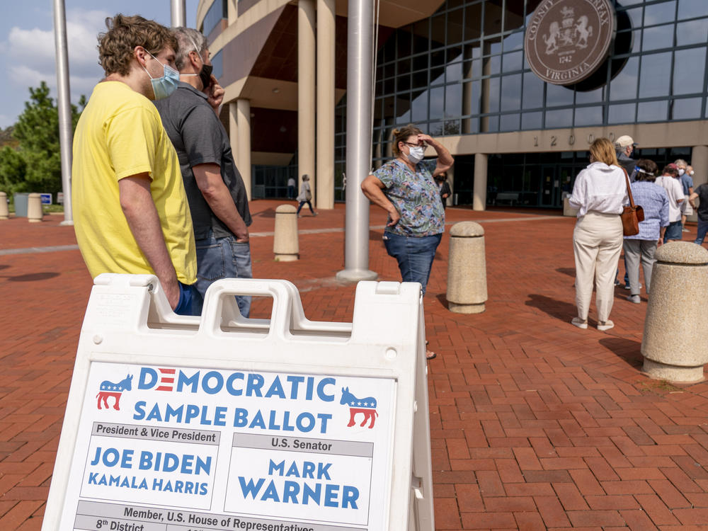 A Democratic sample ballot is on display as hundreds wait in line for early voting at Fairfax County Government Center on Friday in Fairfax, Va.