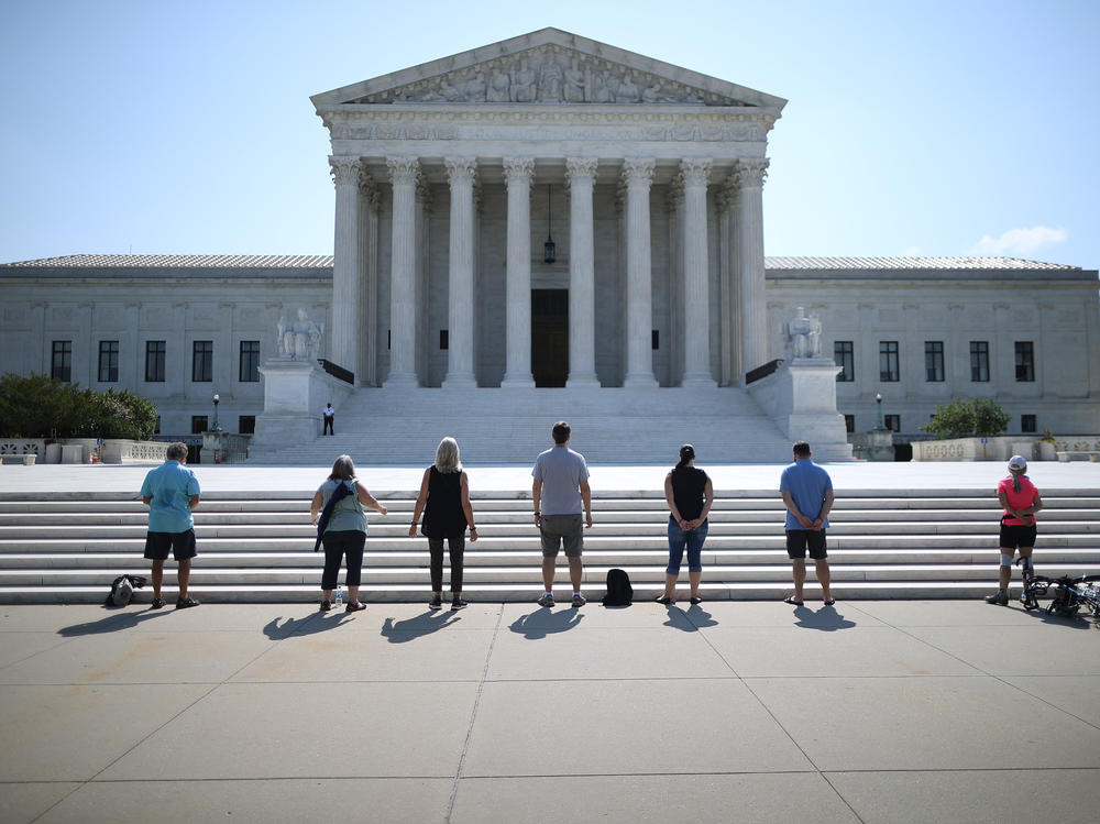 Demonstrators pray in front of the U.S. Supreme Court on July 8, a day the court ruled that employers with religious objections can decline to provide contraception coverage under the Affordable Care Act. With the death of Ruth Bader Ginsburg, the ACA's future is in doubt.