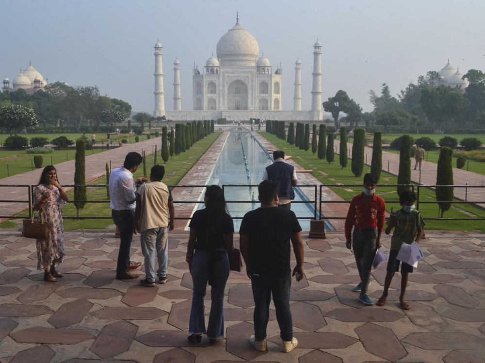 Tourists visit the Taj Mahal on Monday, when it reopened after being closed for more than six months due to the coronavirus pandemic.