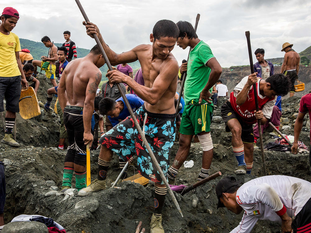 Freelance miners dig for raw jade at a company site in Hpakant, Myanmar, in 2018.