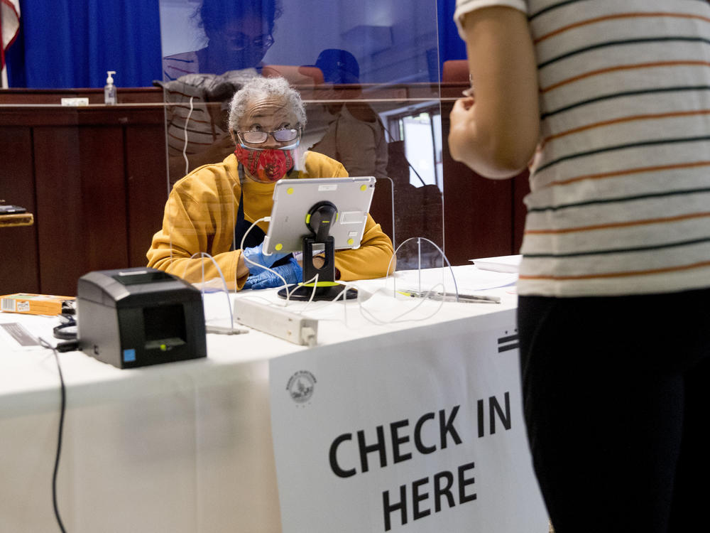 Poll worker Beverly Talley checks in a voter during primary voting in Washington, D.C. on June 2.