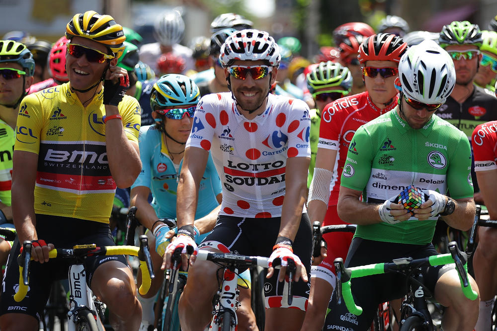 Mark Cavendish of Great Britain works on a Rubik's Cube on the start line prior to stage seven of the 2016 Tour de France.