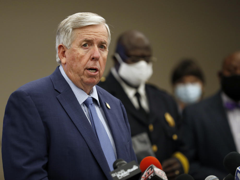 Missouri Gov. Mike Parson, here at an August news conference in St. Louis, says he and his wife, Teresa Parson, 