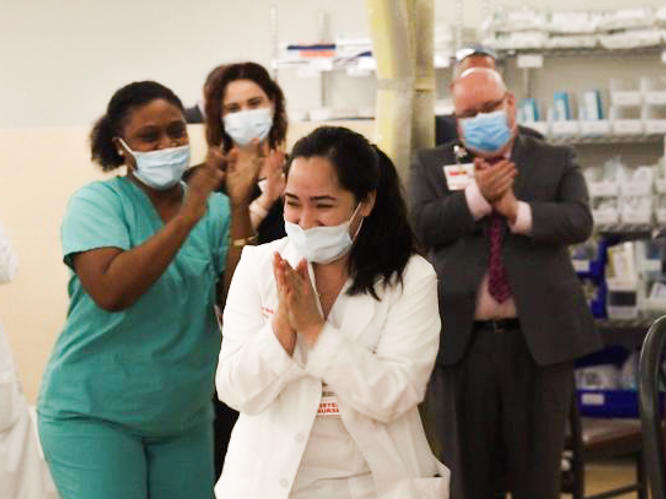 Nurses clap after Kym Villamer and her colleague Dawn Jones sing 