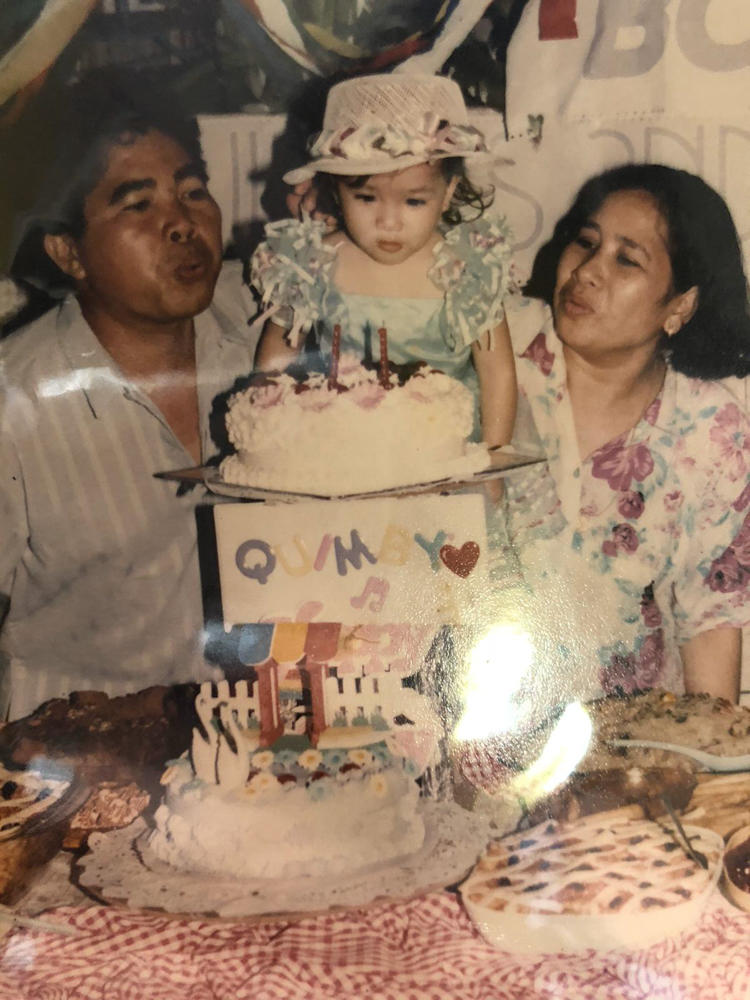 A childhood photo of Kym Villamer celebrating her first birthday with her parents, Baldomero and Bernadette Villamer, in their home in Iriga City, Philippines.