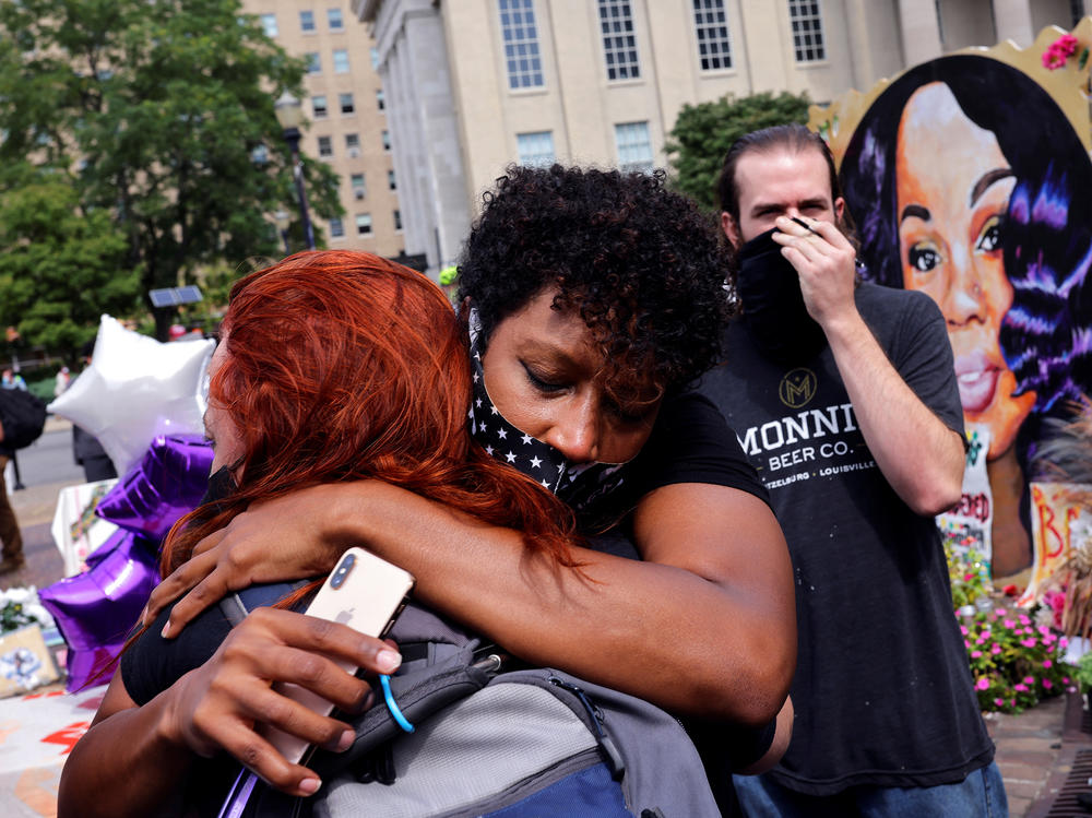 People react after a decision in the criminal case against police officers involved in the death of Breonna Taylor, who was shot dead by police in her apartment, in Louisville.