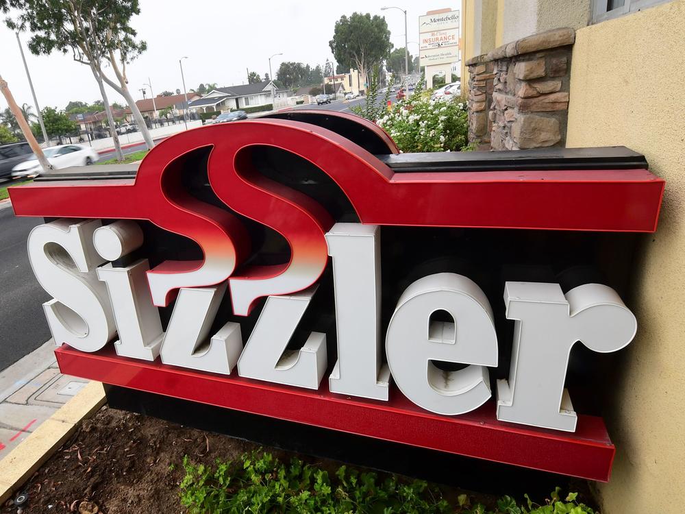 Sizzler USA has filed for bankruptcy as a result of the COVID-19 pandemic and related restrictions. Here, drivers pass a closed Sizzler restaurant in Montebello, Calif.