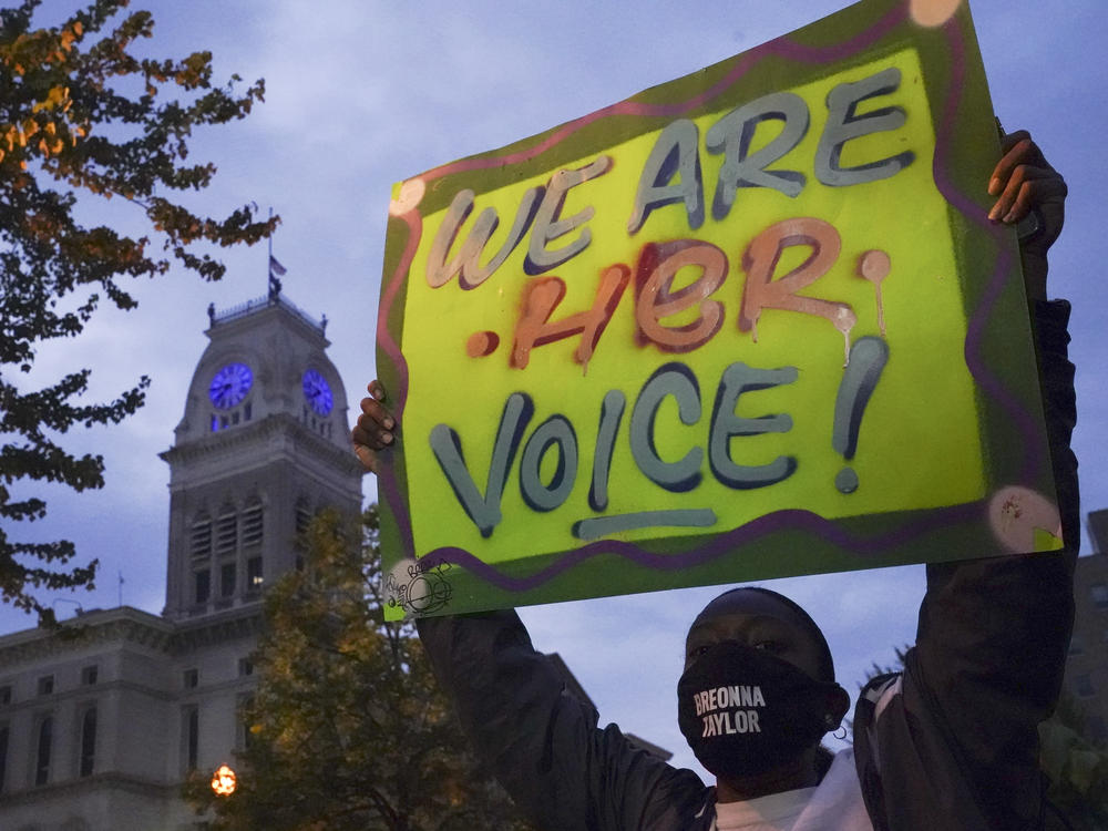 A protester stands in Jefferson Square on Thursday in Louisville, Ky., where hundreds have been holding demonstrations in the aftermath of the grand jury's decision not to charge officers for her death.