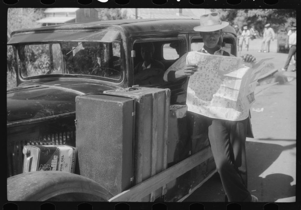 This 1940 photo shows Granville Clarke, a Florida migratory agricultural worker, studying a road map before leaving Elizabeth City, N.C., en route to Bridgeville, Del., to work in a cannery. <em>Driving While Black </em>premieres on PBS on Oct. 13.
