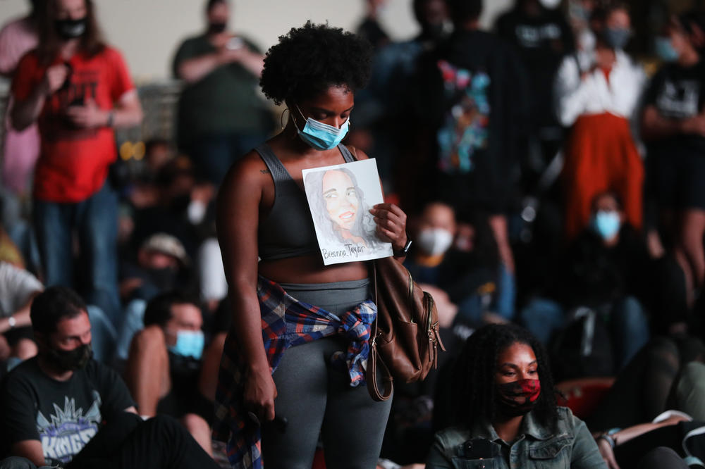 A woman in Brooklyn holds a sign honoring Breonna Taylor during a demonstration in New York City.