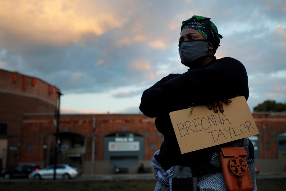 A demonstrator listens to a speech at a vigil in Boston.