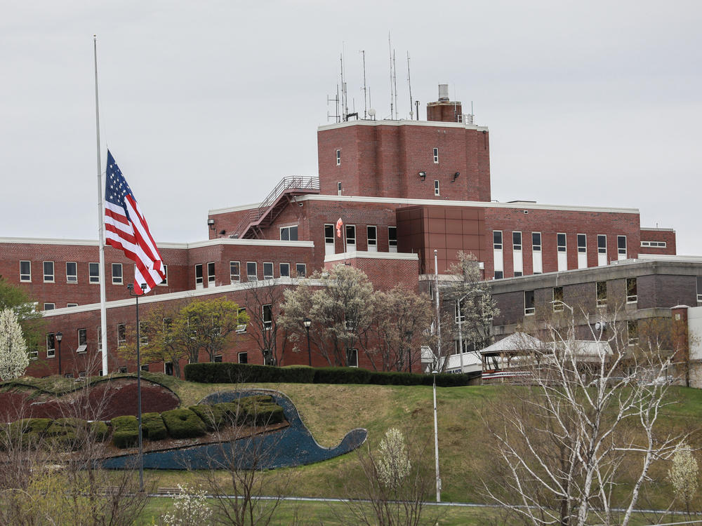An American flag flew at half-mast at the Holyoke Soldiers' Home in Massachusetts last spring, when dozens of veterans died at the facility. Two of its leaders are now facing criminal neglect charges over their handling of a COVID-19 outbreak.