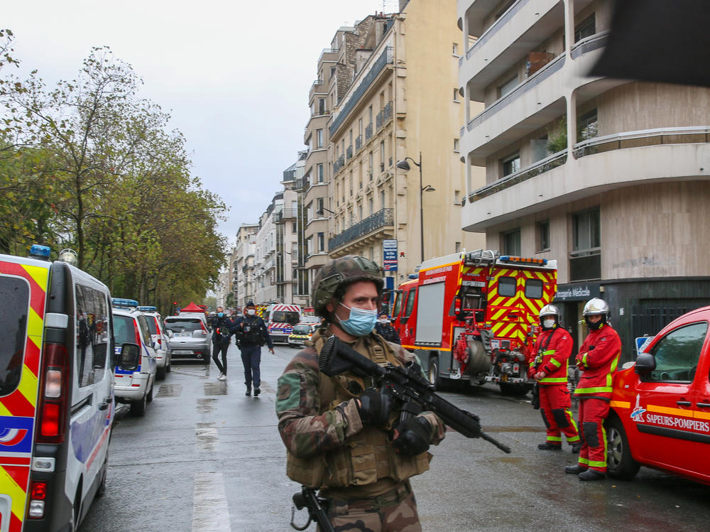 An officer of the French National Gendarmerie guards an area near the former Paris offices of satirical newspaper <em>Charlie Hebdo,</em> where two people were wounded Friday in an attack with a sharp object that one witness described as a hatchet.