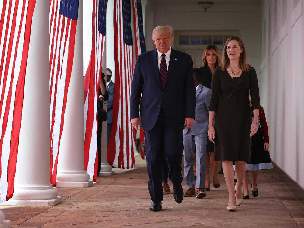 President Trump and Supreme Court nominee Amy Coney Barrett walk along the Rose Garden colonnade on Saturday. The focus on the court just weeks before the election could help energize conservatives in key states.