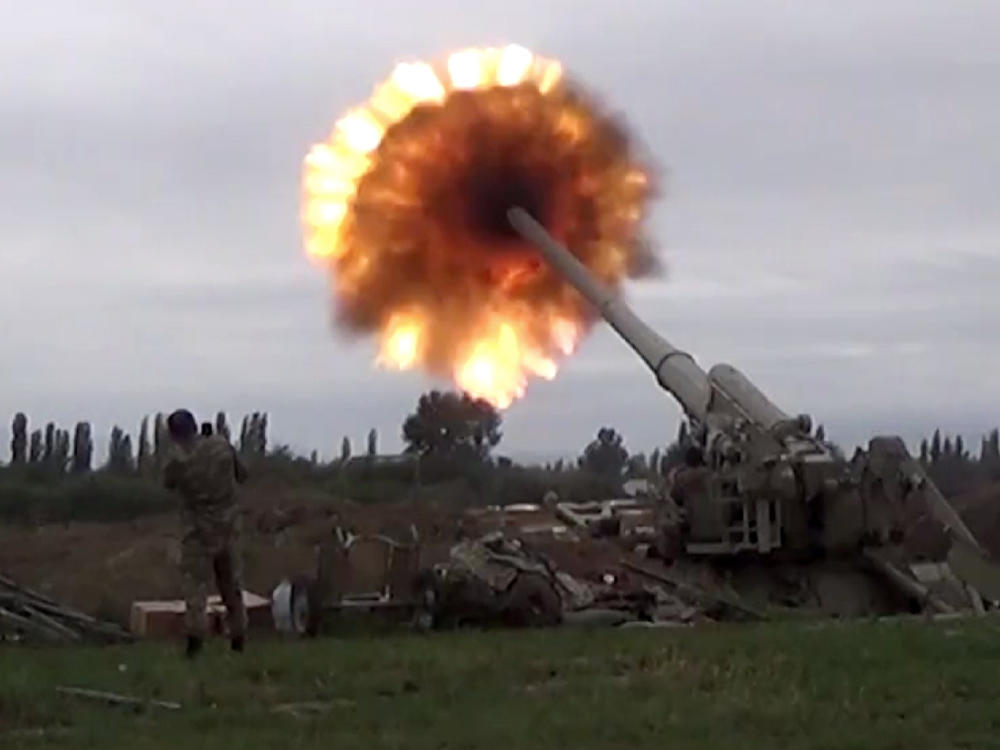 A howitzer fires munitions toward Armenian positions Monday. Violence between Armenia and Azerbaijan erupted Sunday in the disputed region of Nagorno-Karabakh.