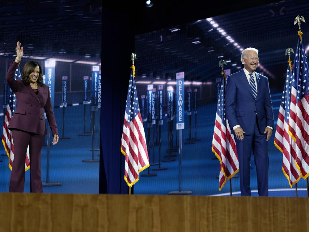 Sen. Kamala Harris stands with former Vice President Joe Biden after speaking last month during the Democratic National Convention.