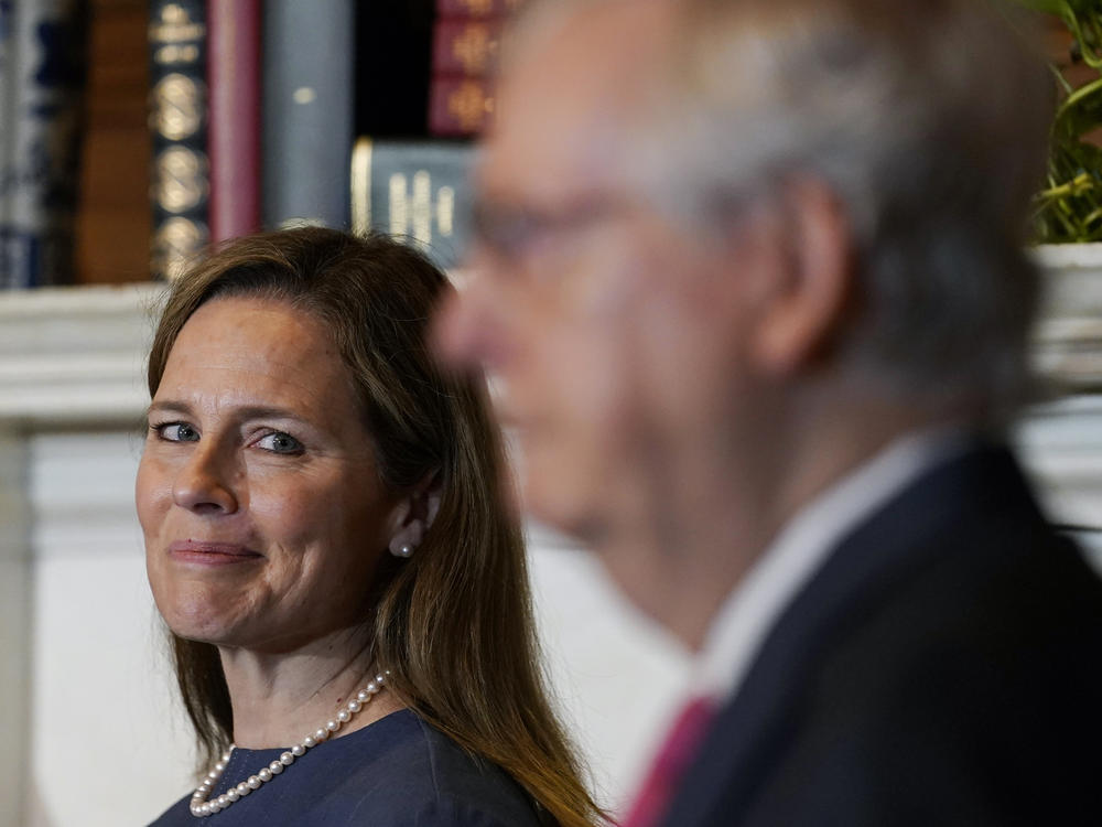 Supreme Court nominee Judge Amy Coney Barrett looks over to Senate Majority Leader Mitch McConnell of Kentucky on Capitol Hill Tuesday.