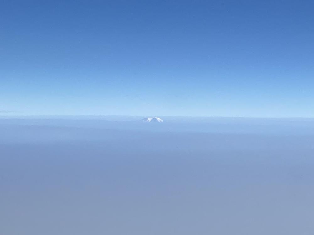 A mountain peak pokes out from a thick blanket of smoke covering much of the West Coast.