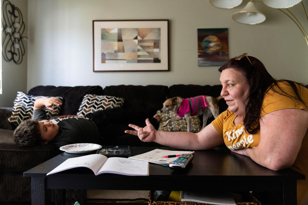 Jessica Barrera helps her son Niko, 10, with math homework after a day of virtual learning at their home in Eau Claire, Wis.