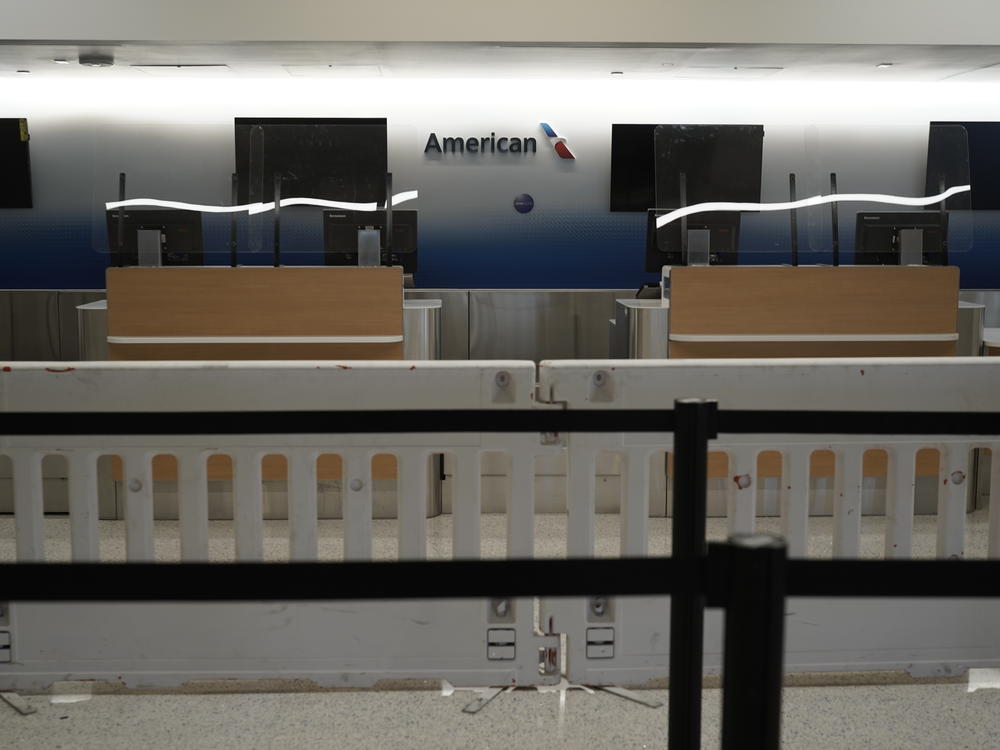 American Airlines check-in counters sit closed last month behind plastic barriers at Los Angeles International Airport.