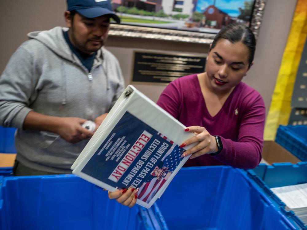 Jonathan Lucero and Valeria Gutierrez prepare to receive ballots at the El Paso County Courthouse during the presidential primary in March.