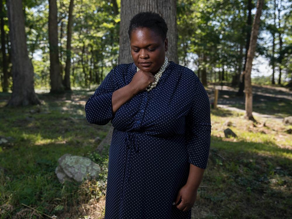 Thomas poses for a portrait at the African American Burial Ground for the Enslaved at Belmont. Thomas restored the graveyard and then used it to bury her teenage son when he drowned in June.