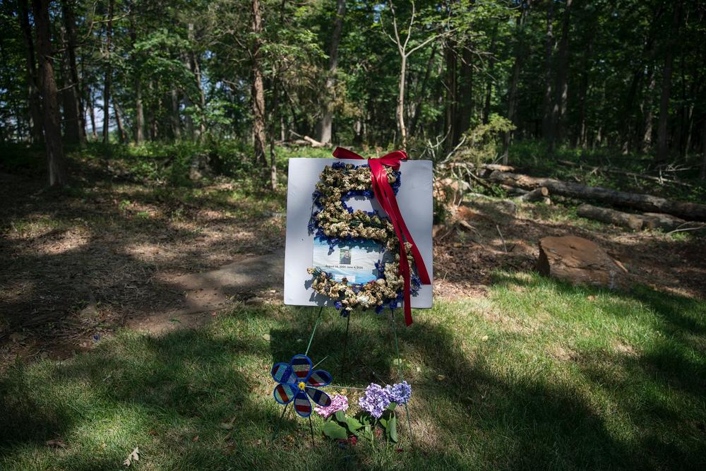 Flowers and a wind spinner mark the grave of Fitz Thomas. 