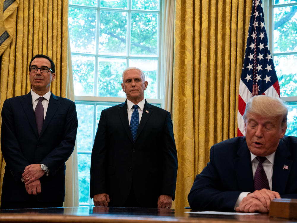 President Trump, flanked by Treasury Secretary Steven Mnuchin (left) and Vice President Pence last month in the Oval Office. Pence and Mnuchin are in the immediate line of succession if Trump is not able to perform his duties.
