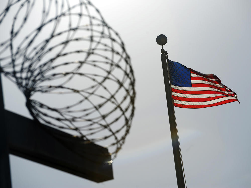 A U.S. flag flies above a fence at the detention facility at the U.S. Naval Station at Guantánamo Bay, Cuba, on Dec. 10, 2008, in an image reviewed by the U.S. military.