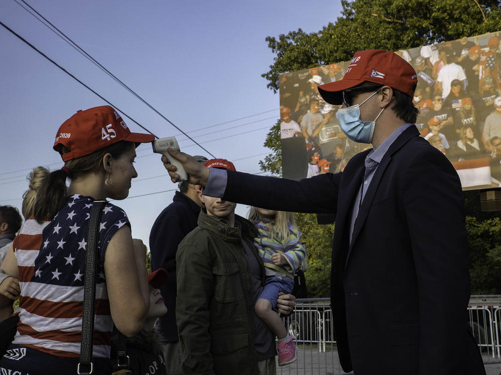 A temperature check is conducted at a Trump campaign rally last month in Toledo, Ohio.