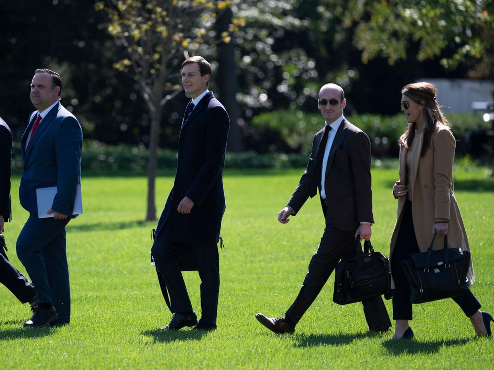 White House staffers and advisers Dan Scavino, Jared Kushner, Stephen Miller and Hope Hicks walk across the South Lawn to Marine One on Wednesday.