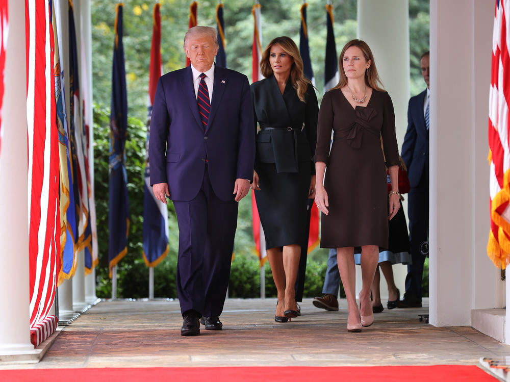 President Trump, first lady Melania Trump and Judge Amy Coney Barrett walk into the Rose Garden for last Saturday's nomination announcement. The first couple have since tested positive for the coronavirus.