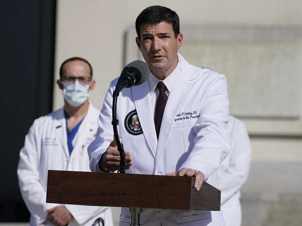Dr. Sean Conley, physician to President Trump, talks with reporters at Walter Reed National Military Medical Center on Monday.