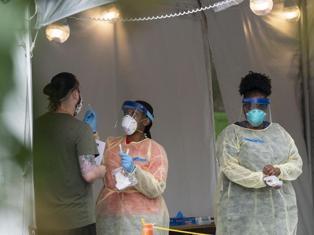 A nurse with the Washington, D.C. Dept. of Health is shown administering a coronavirus test last month. D.C. is now seeing a spike in demand for testing.