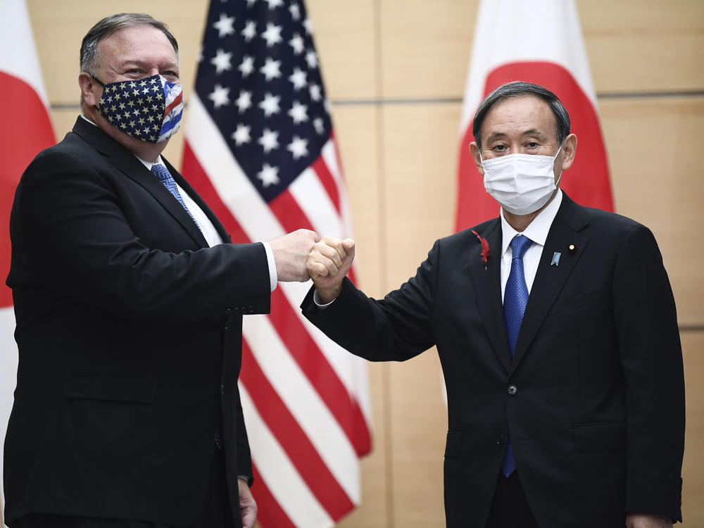 Pompeo and Japanese Prime Minister Yoshihide Suga greet each other Tuesday in Tokyo ahead of the 